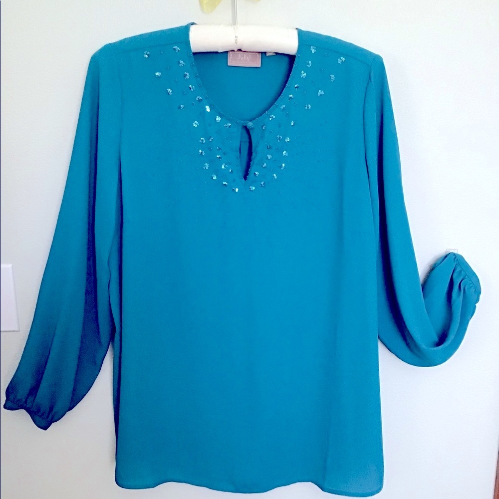 Gorgeous blouse in a turquoise-teal with beautiful beadwork on the collar.